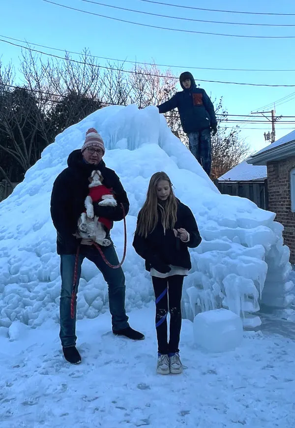 the family posing in front of our igloo